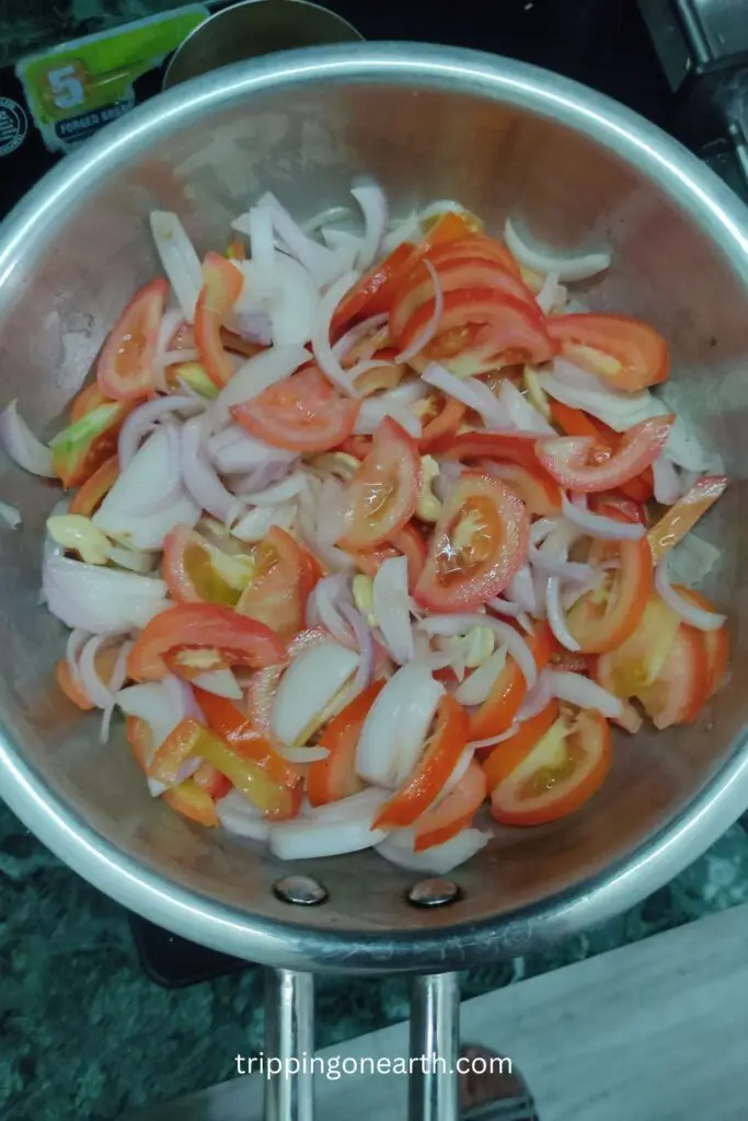 shahi paneer, onions and tomatoes in the pan