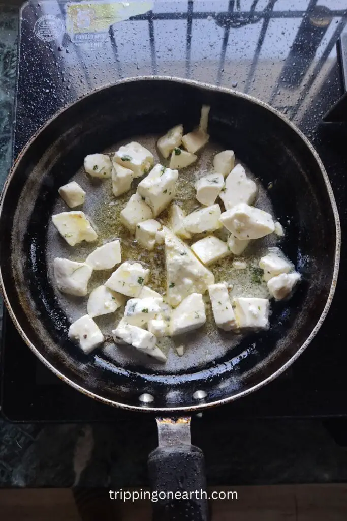 shallow fry paneer in a pan