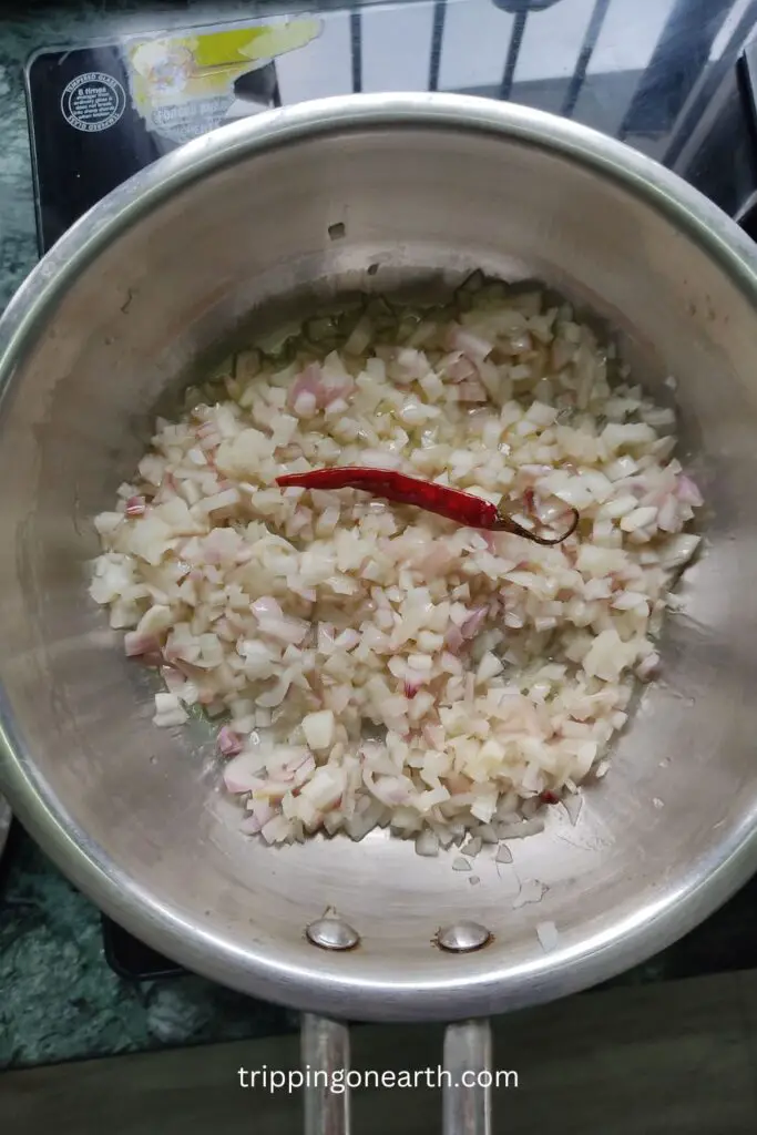 baingan ka bharta. add whole red chilli, garlic and onions