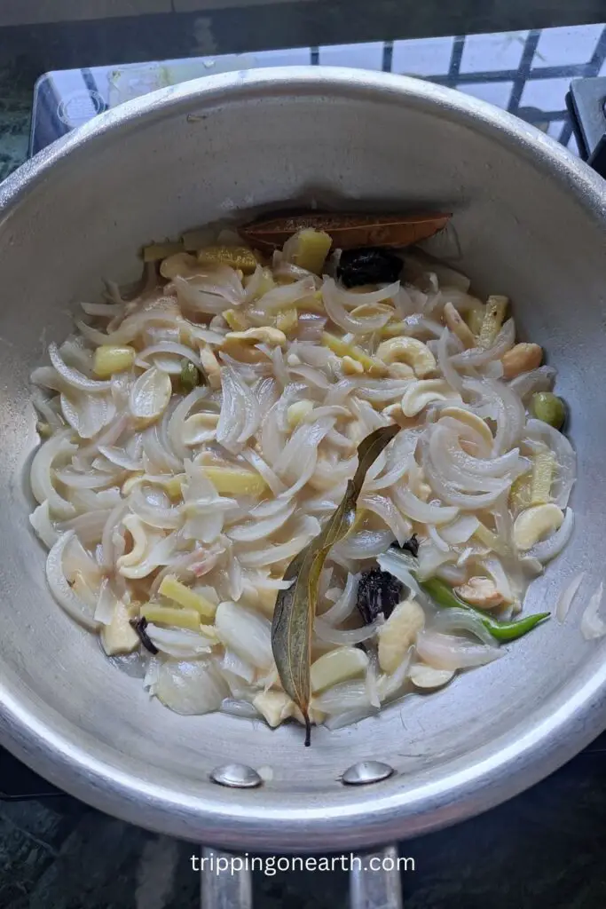 cook and reduce the water till onions and cashews get mushy