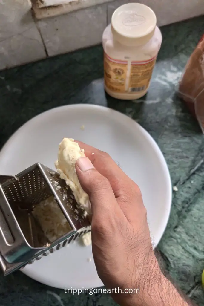 shredding cheese using a grater