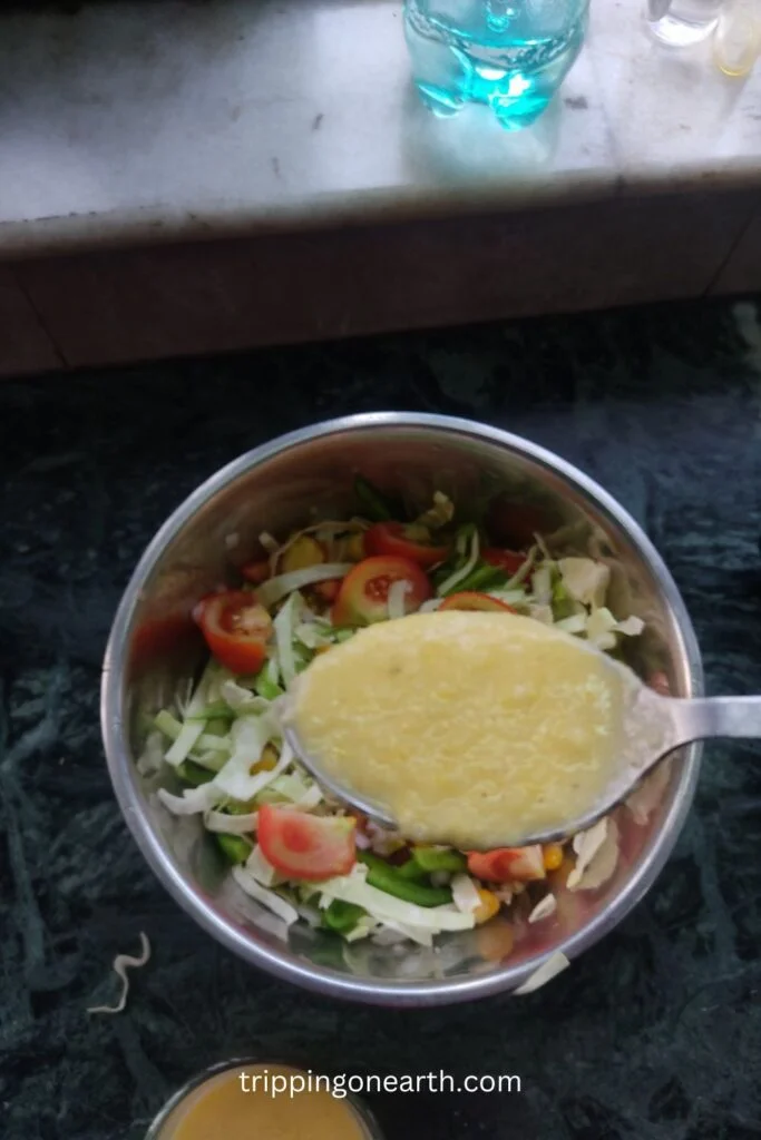 one spoon of sweet corn vinaigrette and golden girl salad in the background
