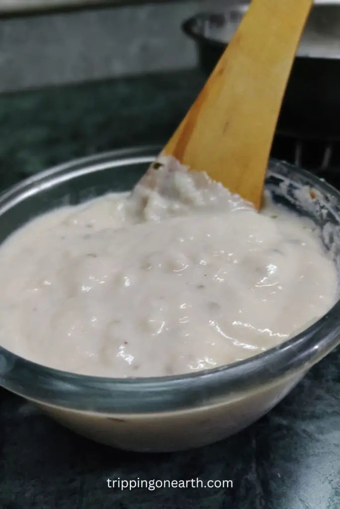 sour cream pasta sauce in a glass bowl with a wooden spatula