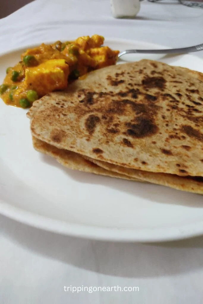 matar paneer without onion and garlic on a plate along with parathas