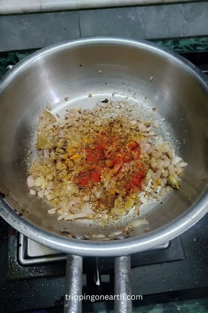 powdered spices added on onions in the pan