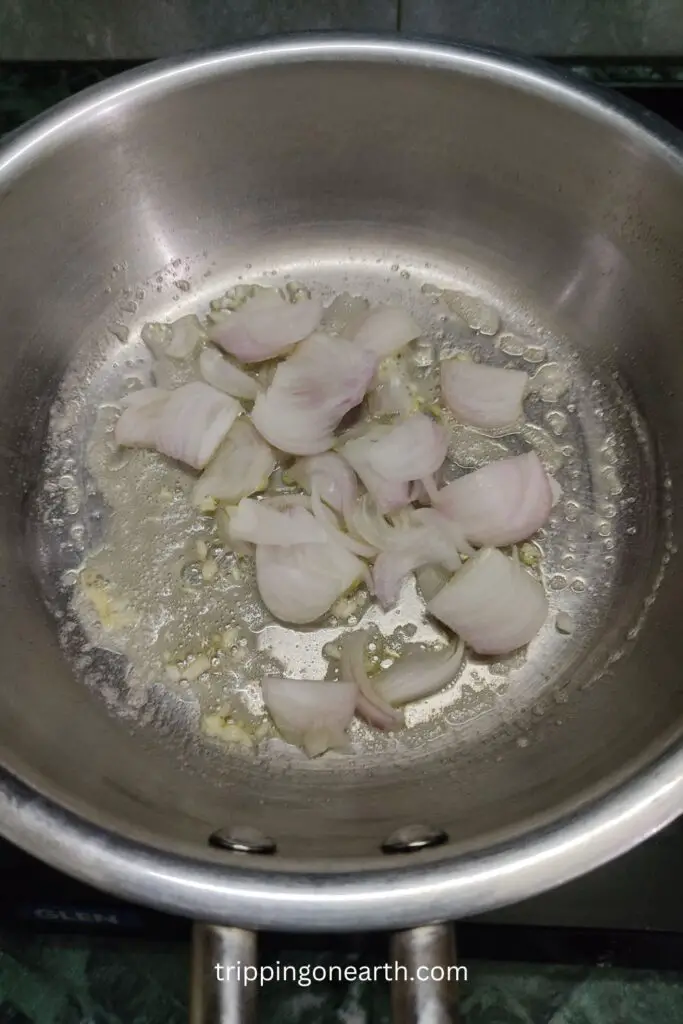garlic and onions cooking in a skillet in melted butter