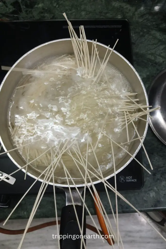 spaghetti pasta strands boiling in a pot