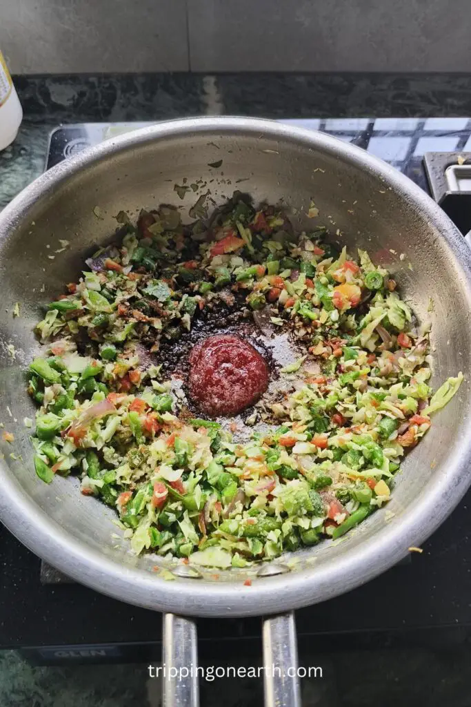 red chili sauce and soy sauce in the center surrounded by the veggies in a wok