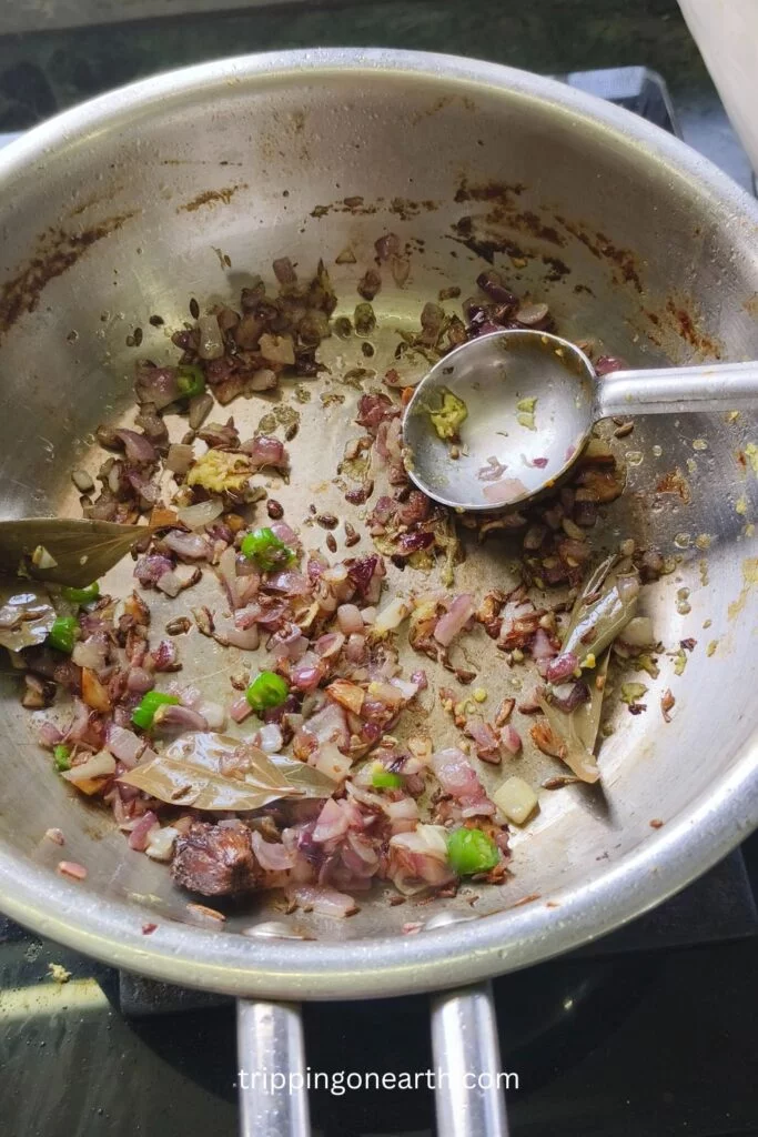 onions and green chillies in the pan