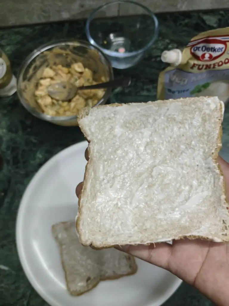 mayonnaise spread on a slice of bread 