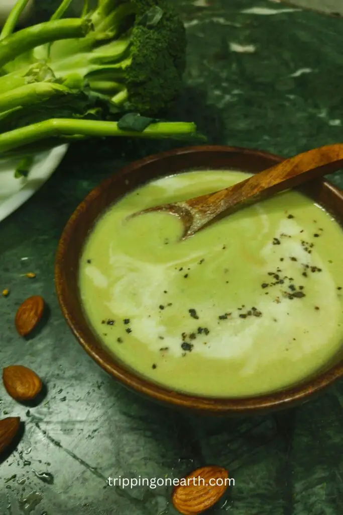 Broccoli almond soup in a wooden bowl and a spoon