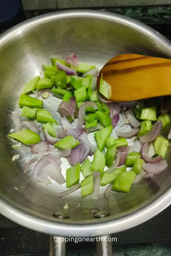 chopped onion and broccoli stems in the skillet