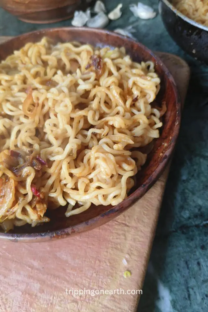 fried maggi on a wooden plate
