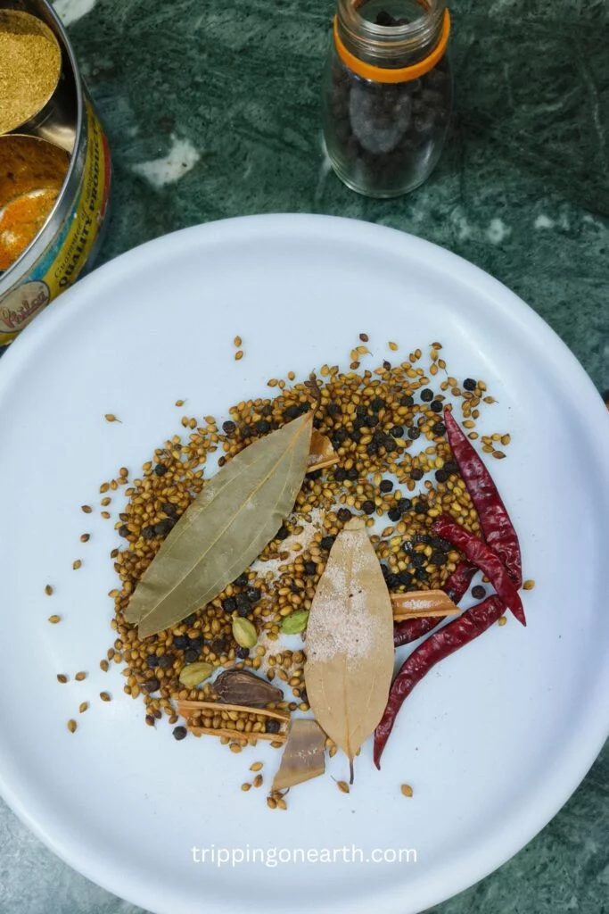 whole spices resting on a white plate after roasting