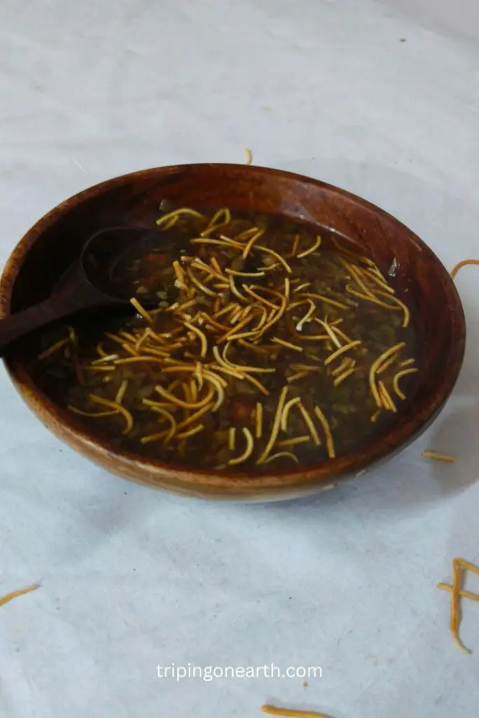 veg manchow soup in a wooden bowl and a wooden spoon