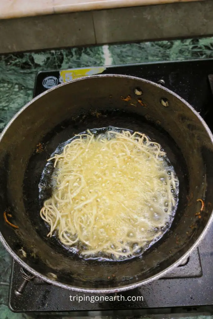 noodles frying in a wok