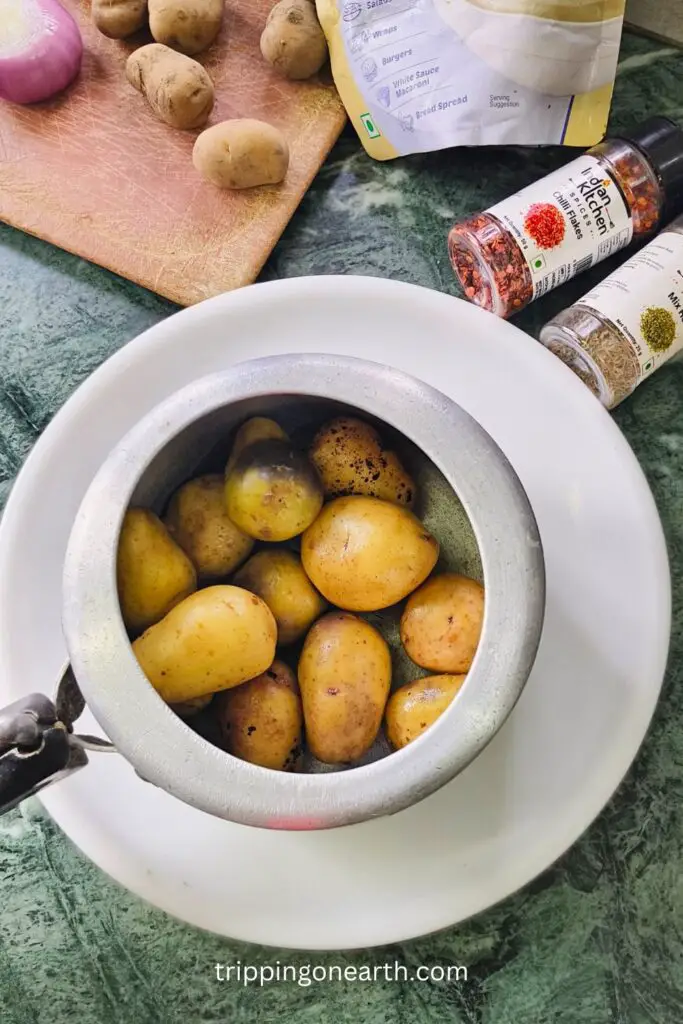baby potatoes in a pressure cooker, rested on a white plate