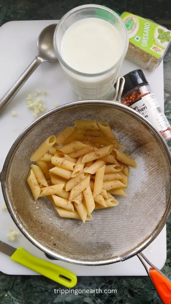 boiled penne pasta in a seive