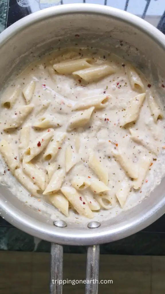 penne pasta with alfredo sauce in a skillet