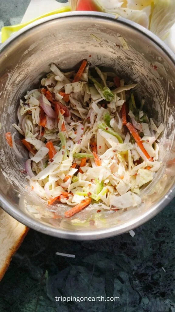 Mayonnaise mixed together with veggies in a bowl