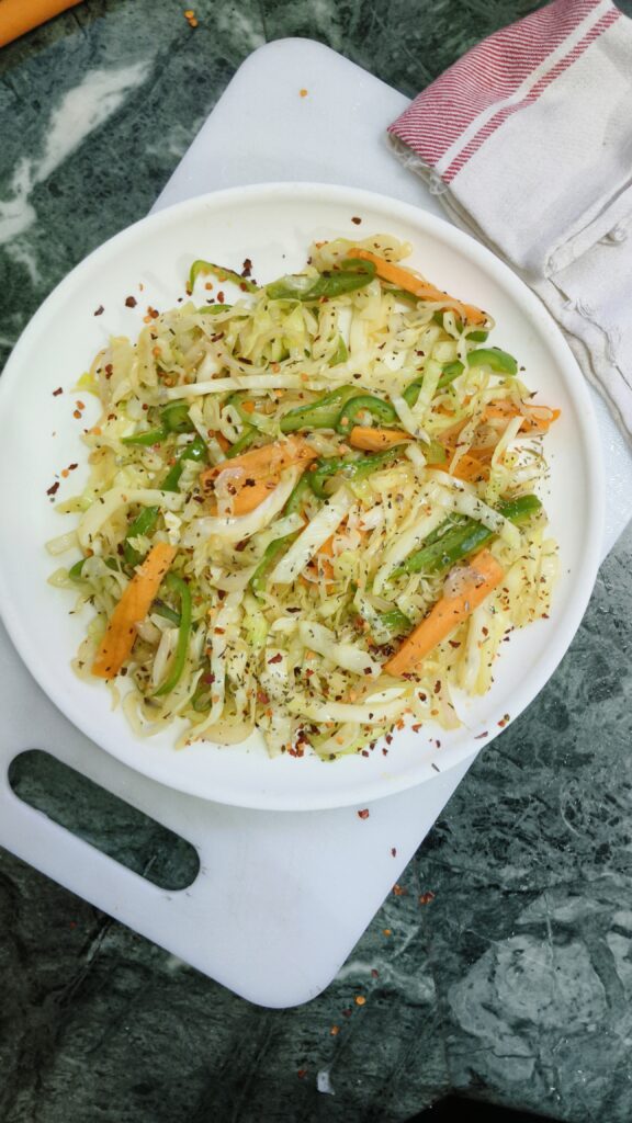 cabbage carrot stir fry on a white plate