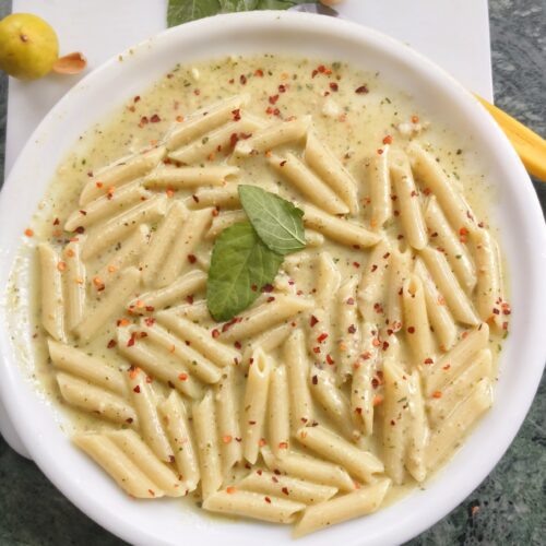 pasta alfredo pesto on a white plate