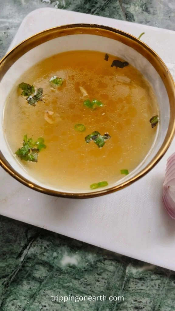 Clear soup in a white bowl