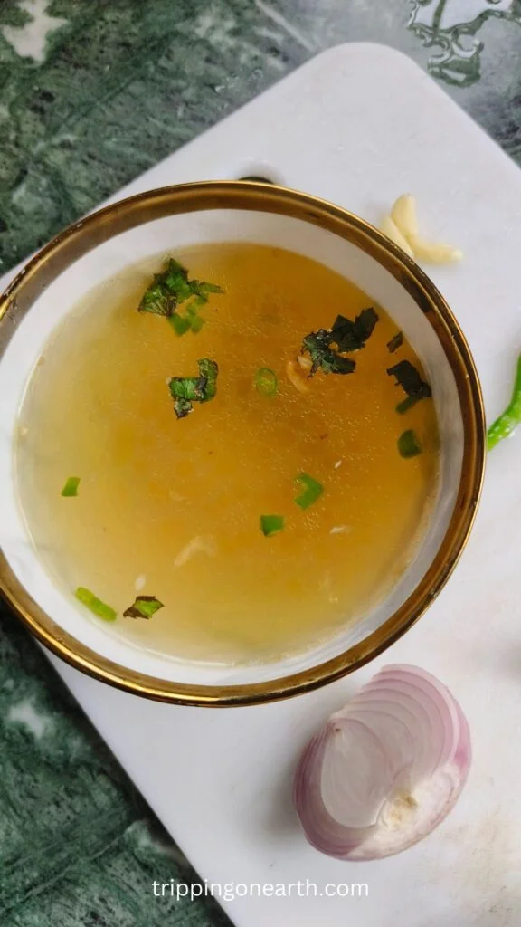 Clear soup in a white bowl