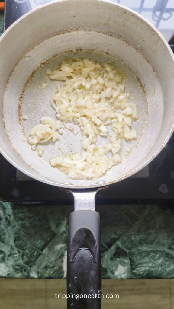 Onions getting sauteed in butter in a skillet