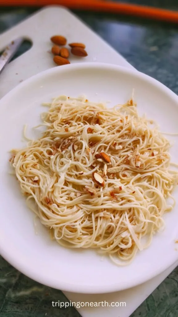 Noodles Almondine on a white plate