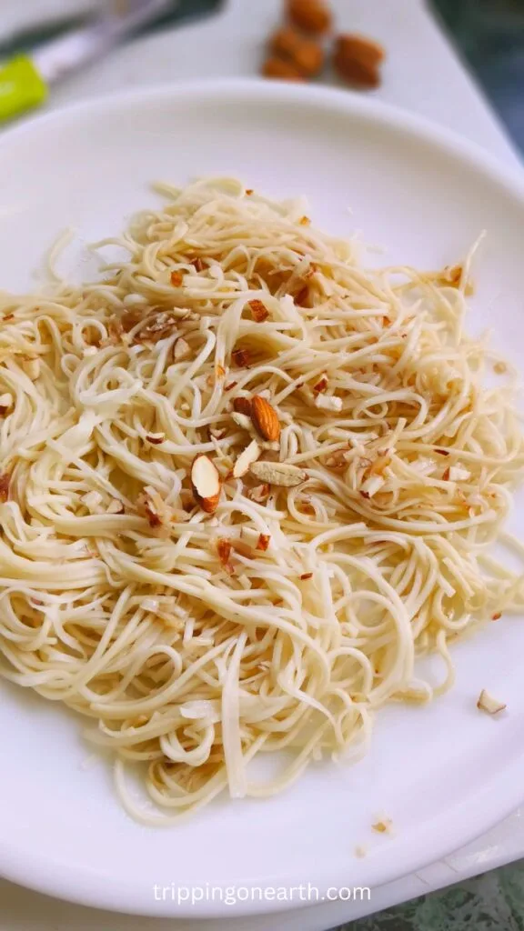 Noodles Almondine on a white plate