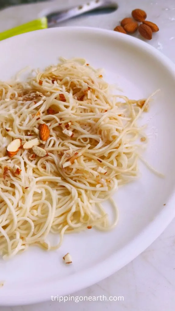 Noodles Almondine on a white plate