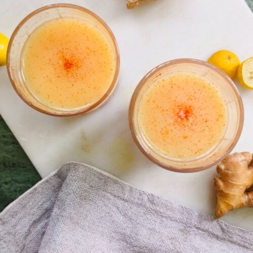 Carrot ginger turmeric juice in a couple of glasses