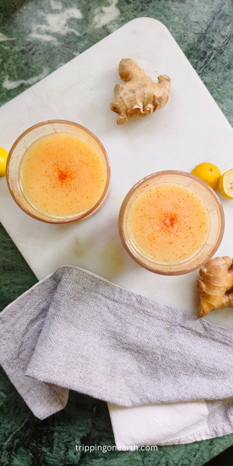 Carrot ginger turmeric juice in a couple of glasses