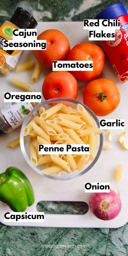 Vegan Cajun Pasta ingredients laid out on a white chopping board