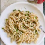 pasta and peas on a white plate