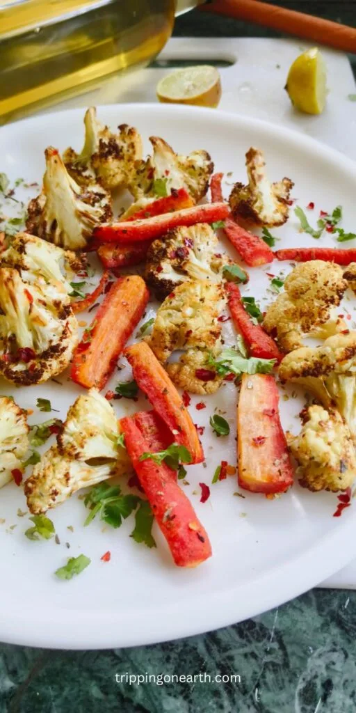 Roasted cauliflower and carrots on a white plate