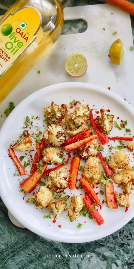 Roasted cauliflower and carrots on a white plate