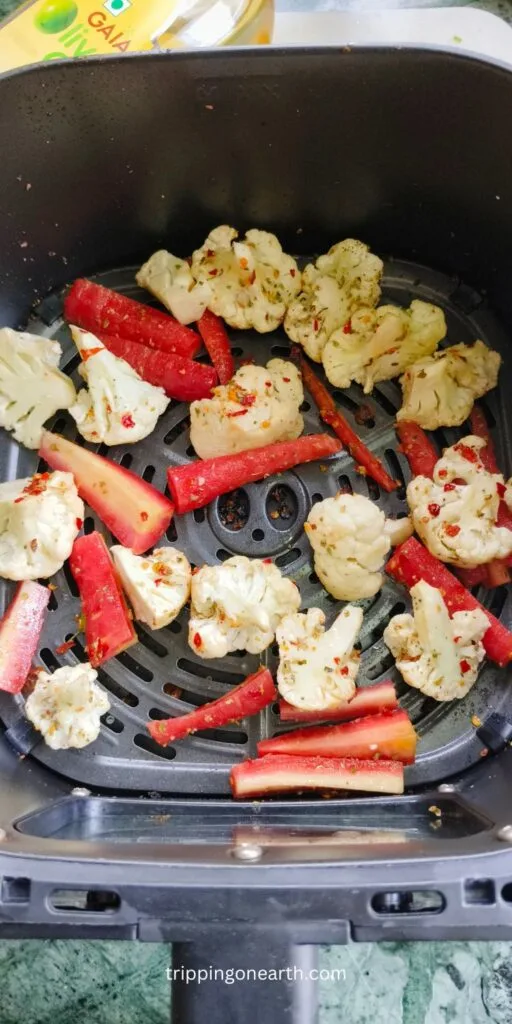 Roasted cauliflower and carrots in the air fryer basket