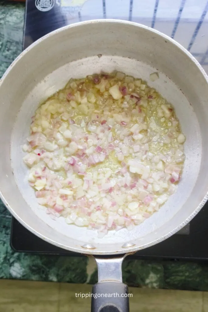 onion and garlic getting cooked in a skillet
