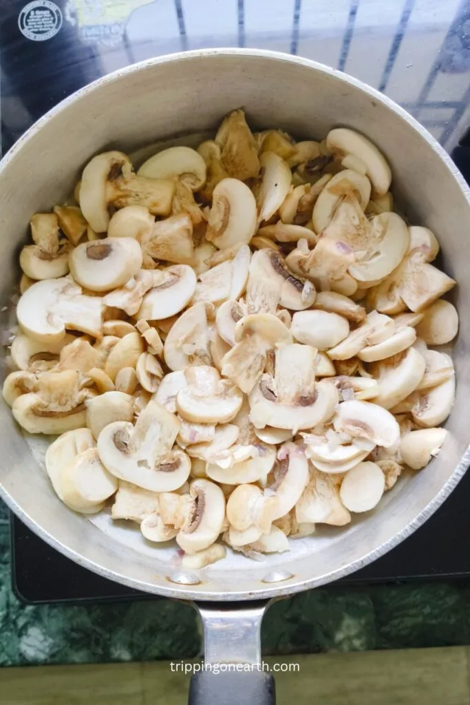 sliced mushrooms getting cooked in a skillet